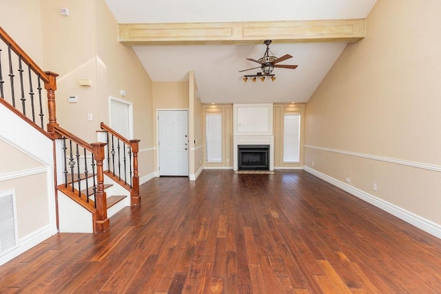 unfurnished living room with ceiling fan, high vaulted ceiling, beam ceiling, and dark hardwood / wood-style flooring