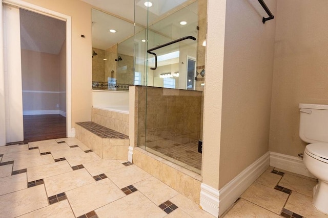 bathroom with tile patterned floors, toilet, and walk in shower