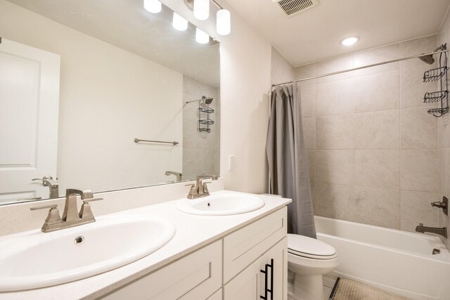 full bathroom with tile patterned flooring, shower / bath combo, toilet, and vanity