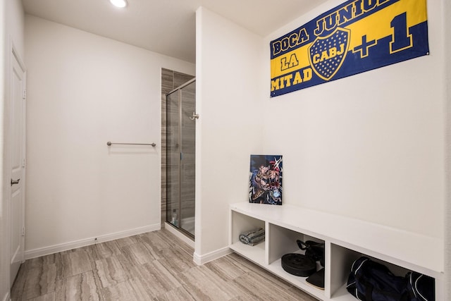 bathroom featuring tiled shower and hardwood / wood-style floors