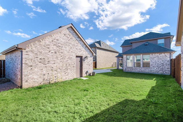 rear view of house featuring a lawn