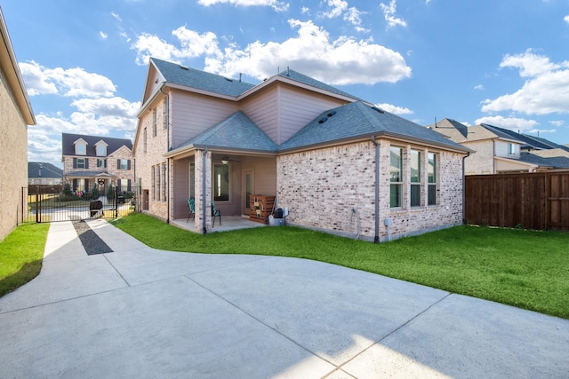 back of house featuring a yard, a patio, and ceiling fan