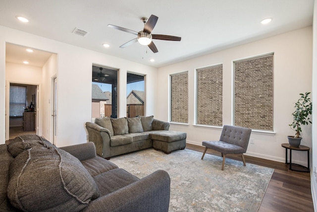 living room with dark hardwood / wood-style floors and ceiling fan