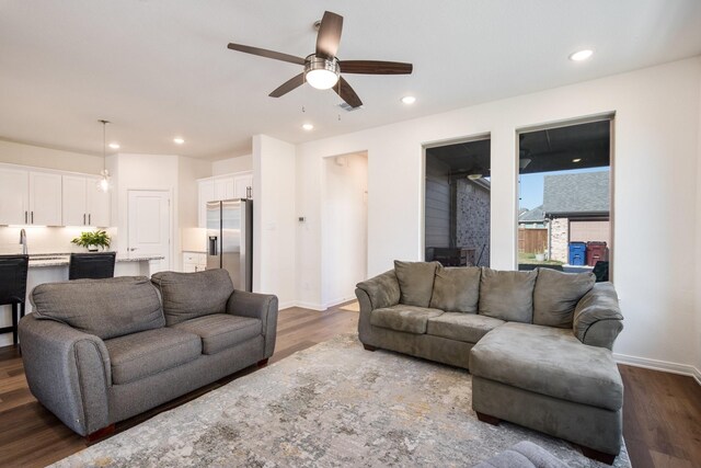 living room with hardwood / wood-style floors and ceiling fan