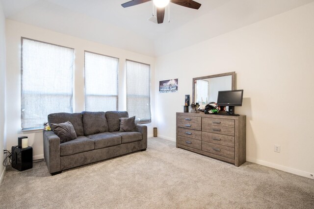 carpeted living room featuring a wealth of natural light and ceiling fan