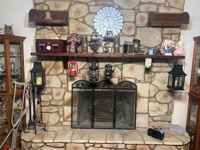 interior details featuring a stone fireplace