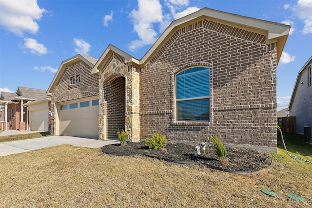 view of front of home with central AC unit and a garage