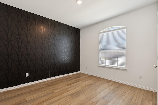 spare room featuring light hardwood / wood-style floors