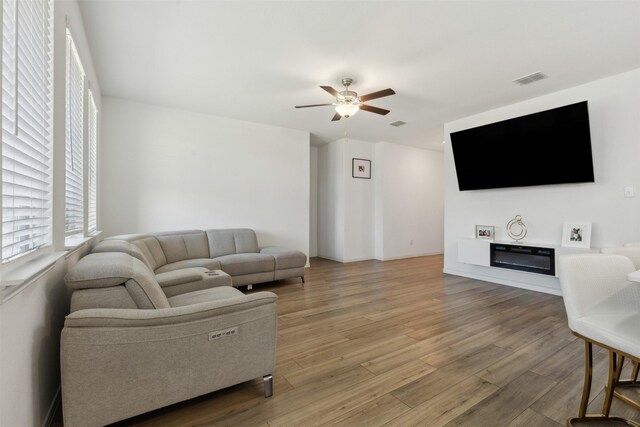 living room featuring ceiling fan and hardwood / wood-style floors