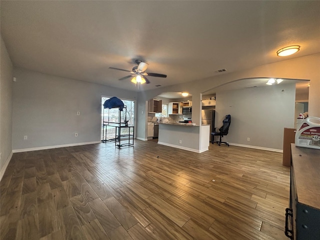 unfurnished living room featuring ceiling fan and dark hardwood / wood-style floors