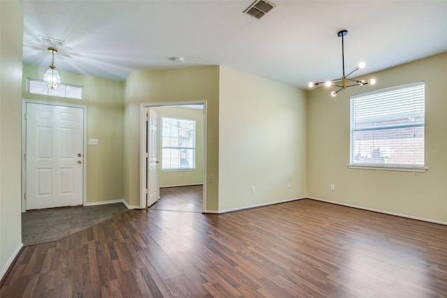 entryway featuring a notable chandelier and dark hardwood / wood-style floors