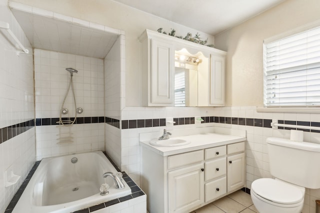 bathroom featuring tile patterned floors, vanity, a bath, tile walls, and toilet