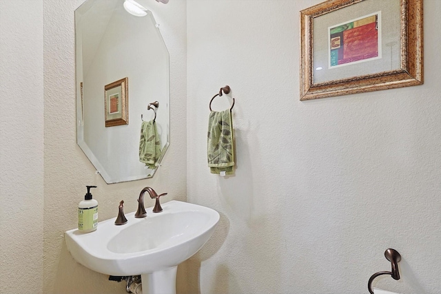 bathroom with a sink and a textured wall