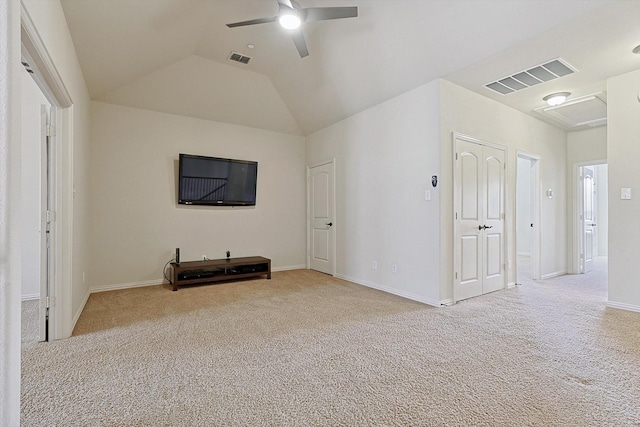 unfurnished living room featuring ceiling fan, visible vents, vaulted ceiling, and carpet flooring