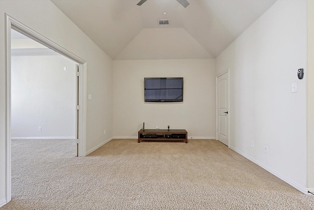 empty room with lofted ceiling, visible vents, carpet flooring, ceiling fan, and baseboards