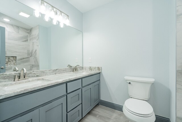 bathroom featuring hardwood / wood-style flooring, vanity, and toilet