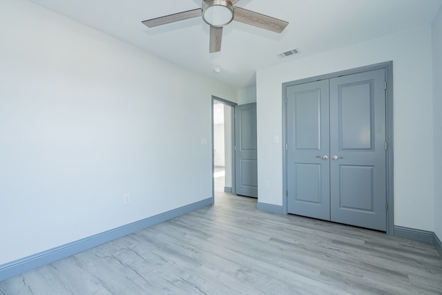 unfurnished bedroom with a closet, ceiling fan, and light hardwood / wood-style flooring