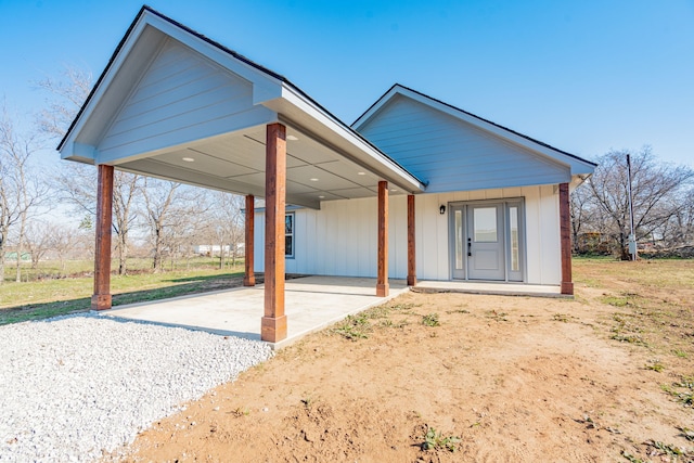 rear view of property featuring a carport