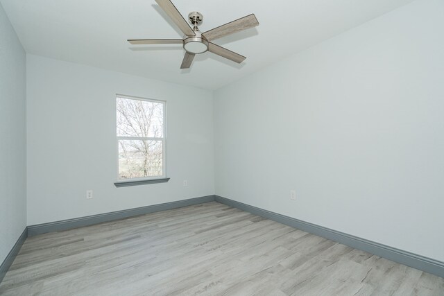 empty room with ceiling fan and light hardwood / wood-style floors