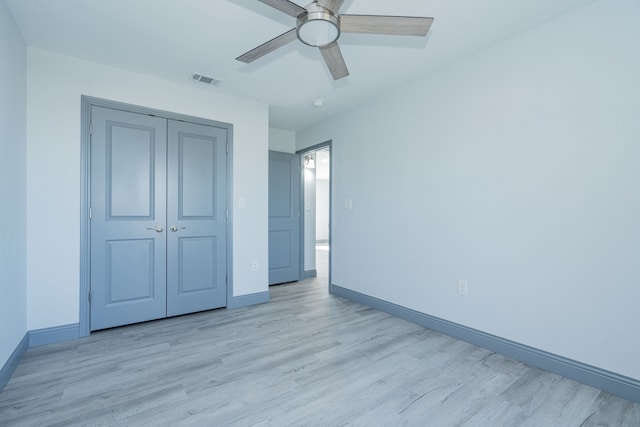 unfurnished bedroom featuring a closet, ceiling fan, and light wood-type flooring