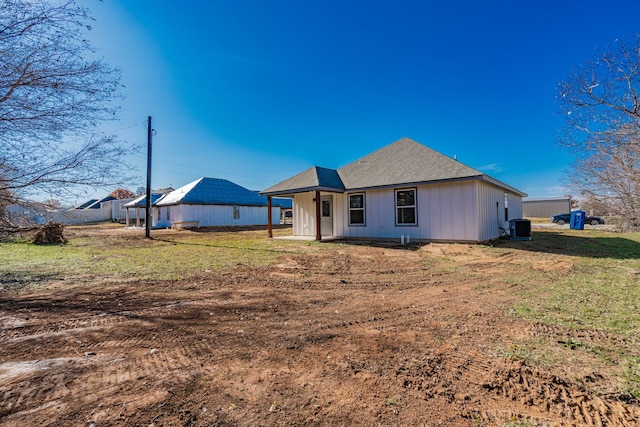 view of front of home featuring a front lawn and central air condition unit