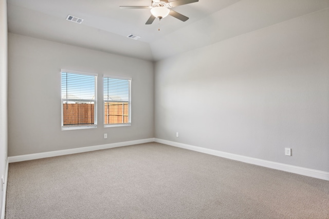 carpeted spare room featuring ceiling fan and lofted ceiling