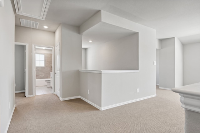 hallway with light colored carpet