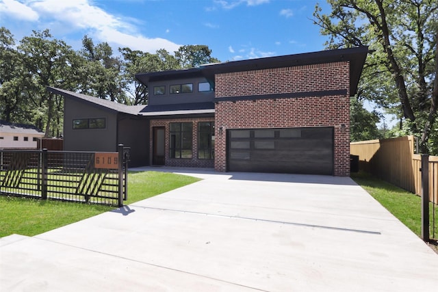 view of front of home with a garage and a front lawn