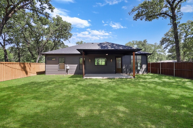 back of house featuring a patio area and a yard