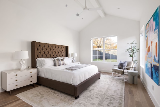 bedroom featuring ceiling fan, hardwood / wood-style floors, high vaulted ceiling, and beamed ceiling