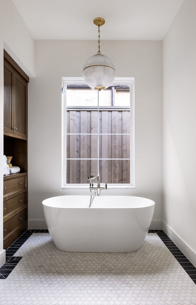 bathroom with tile patterned floors and a tub