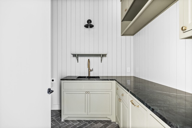 kitchen with dark stone countertops and sink