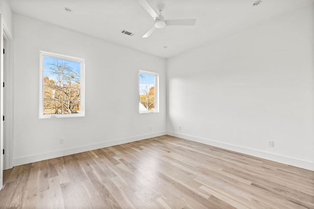 spare room with ceiling fan and light wood-type flooring