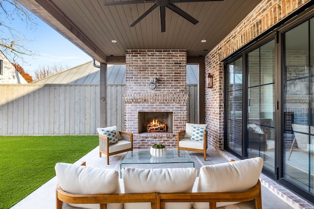 view of patio featuring ceiling fan and an outdoor living space with a fireplace