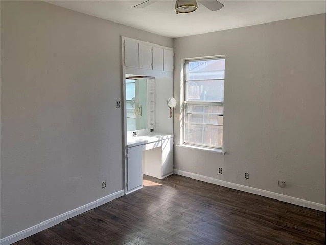 interior space featuring dark wood-type flooring and ceiling fan