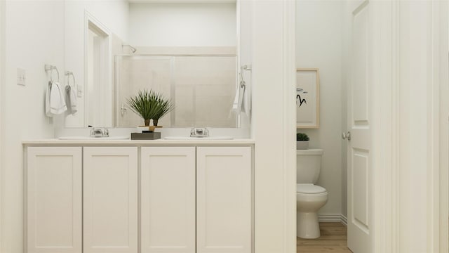 bathroom with vanity, hardwood / wood-style flooring, toilet, and walk in shower