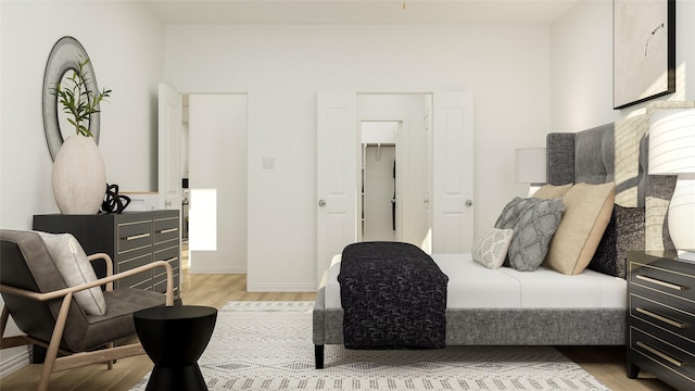 bedroom featuring light wood-type flooring, a spacious closet, and a closet