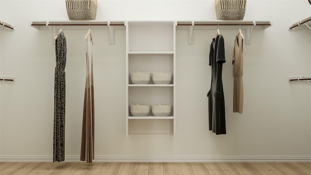 spacious closet with light hardwood / wood-style flooring