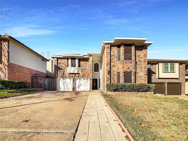 view of front facade featuring a garage and a front lawn