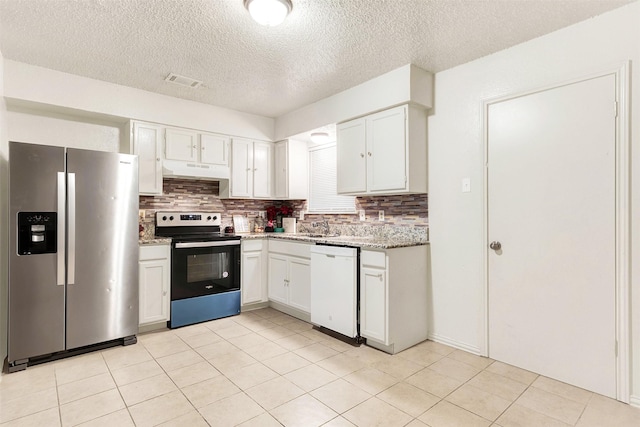 kitchen featuring sink, white cabinetry, light stone counters, appliances with stainless steel finishes, and backsplash