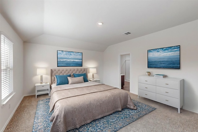 bedroom with light carpet and vaulted ceiling