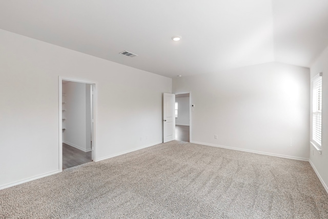 spare room with lofted ceiling and carpet floors