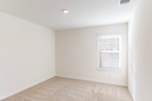 spare room featuring light colored carpet