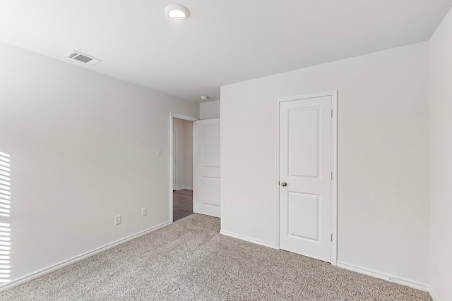 unfurnished bedroom with a closet and carpet floors