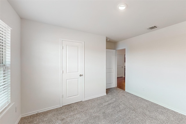 unfurnished bedroom with a closet and carpet floors