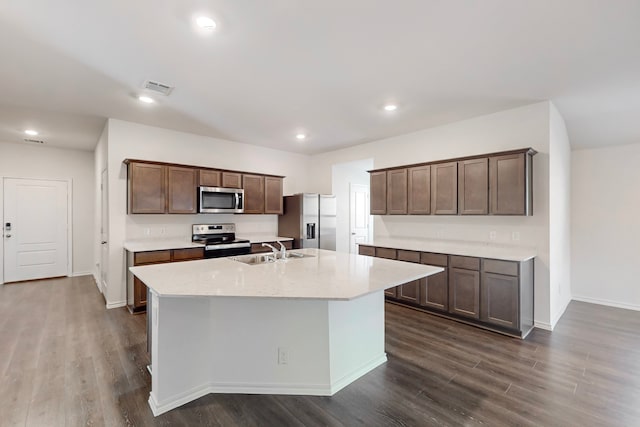 kitchen featuring a center island with sink, sink, dark hardwood / wood-style flooring, dark brown cabinetry, and stainless steel appliances