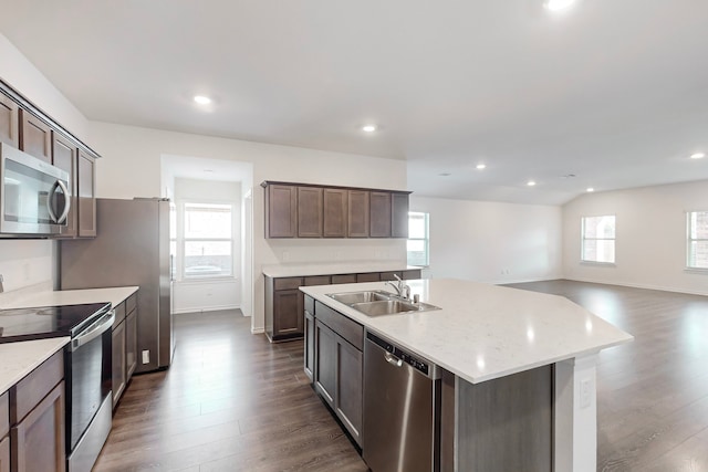 kitchen with a kitchen island with sink, a wealth of natural light, sink, and stainless steel appliances