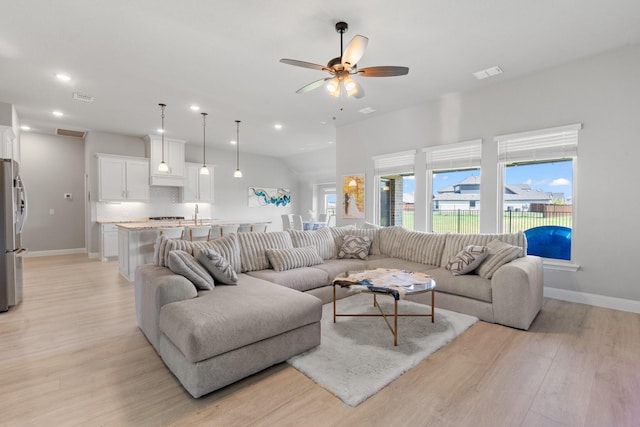 living room featuring ceiling fan and light hardwood / wood-style flooring