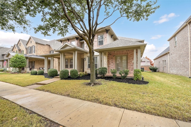 view of front of home with a porch and a front lawn