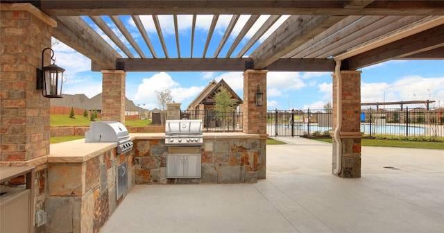 view of patio / terrace with a pergola, an outdoor kitchen, and grilling area